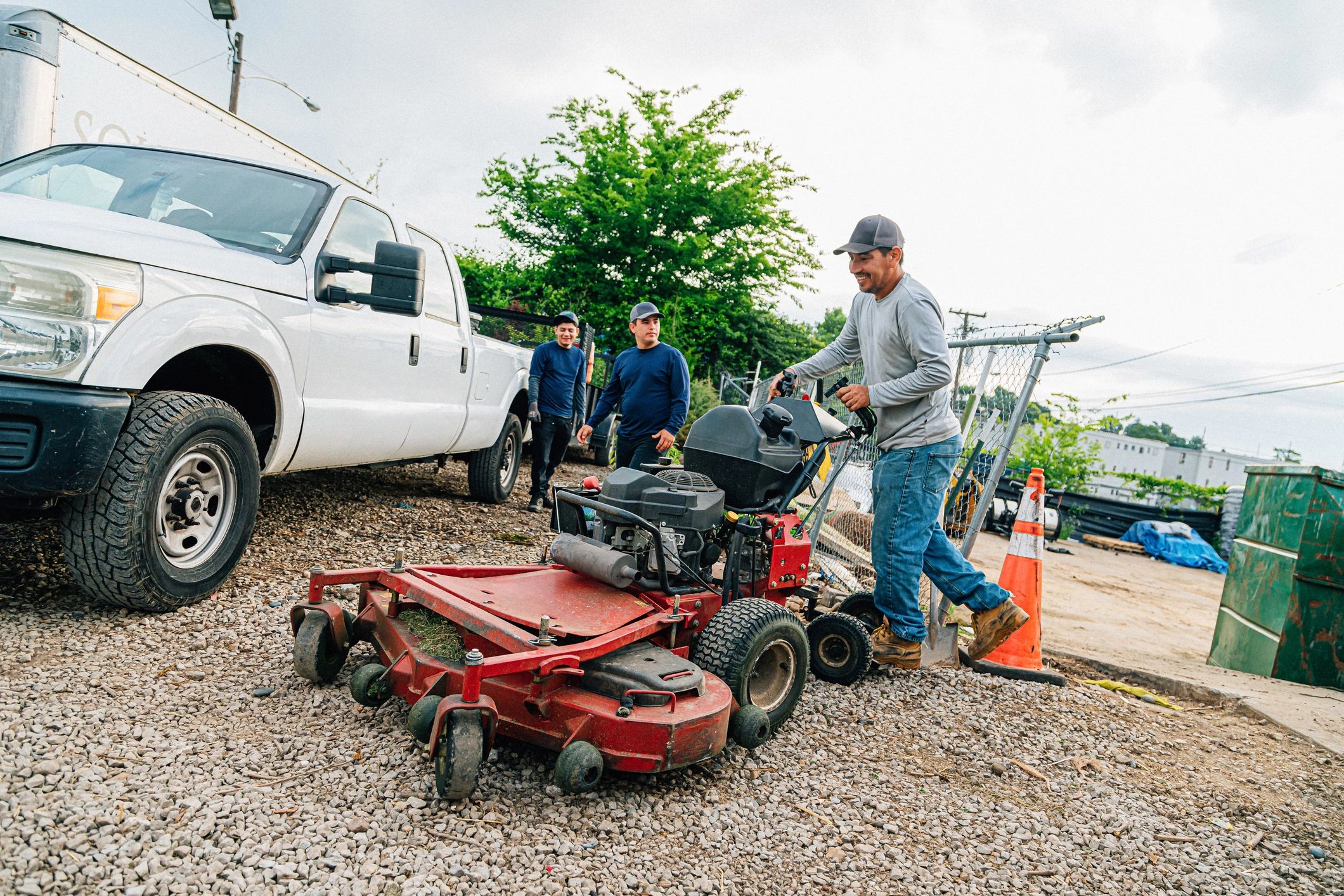 Landscaping professional loading a mower for a day of lawn care