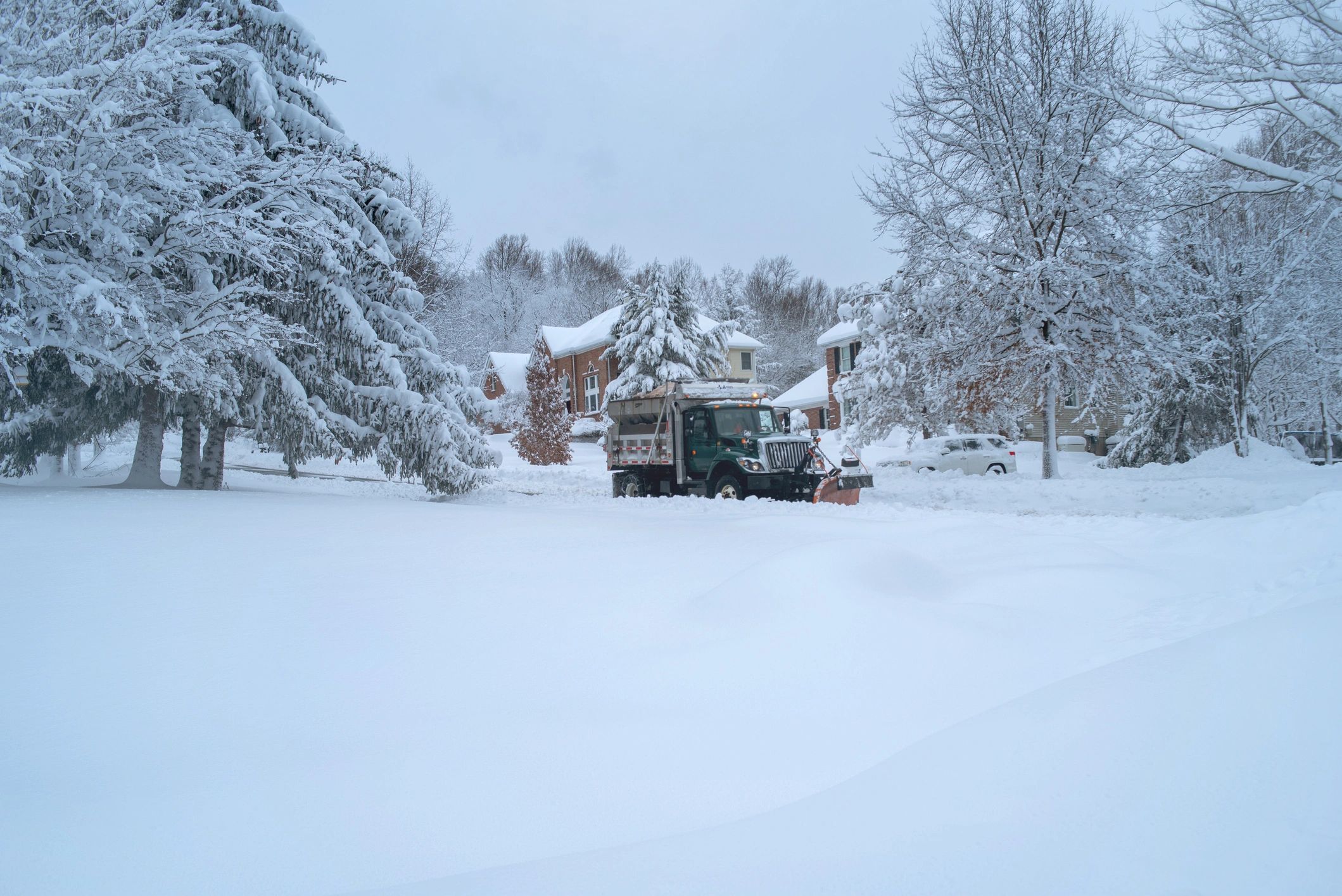 Snowplow truck clearing a snowy street
